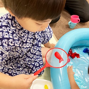 金魚すくいをする子ども